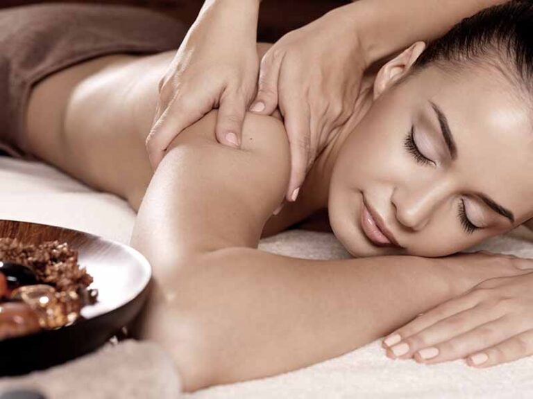 Masseur doing massage on woman body in the spa salon. Beauty treatment concept.
